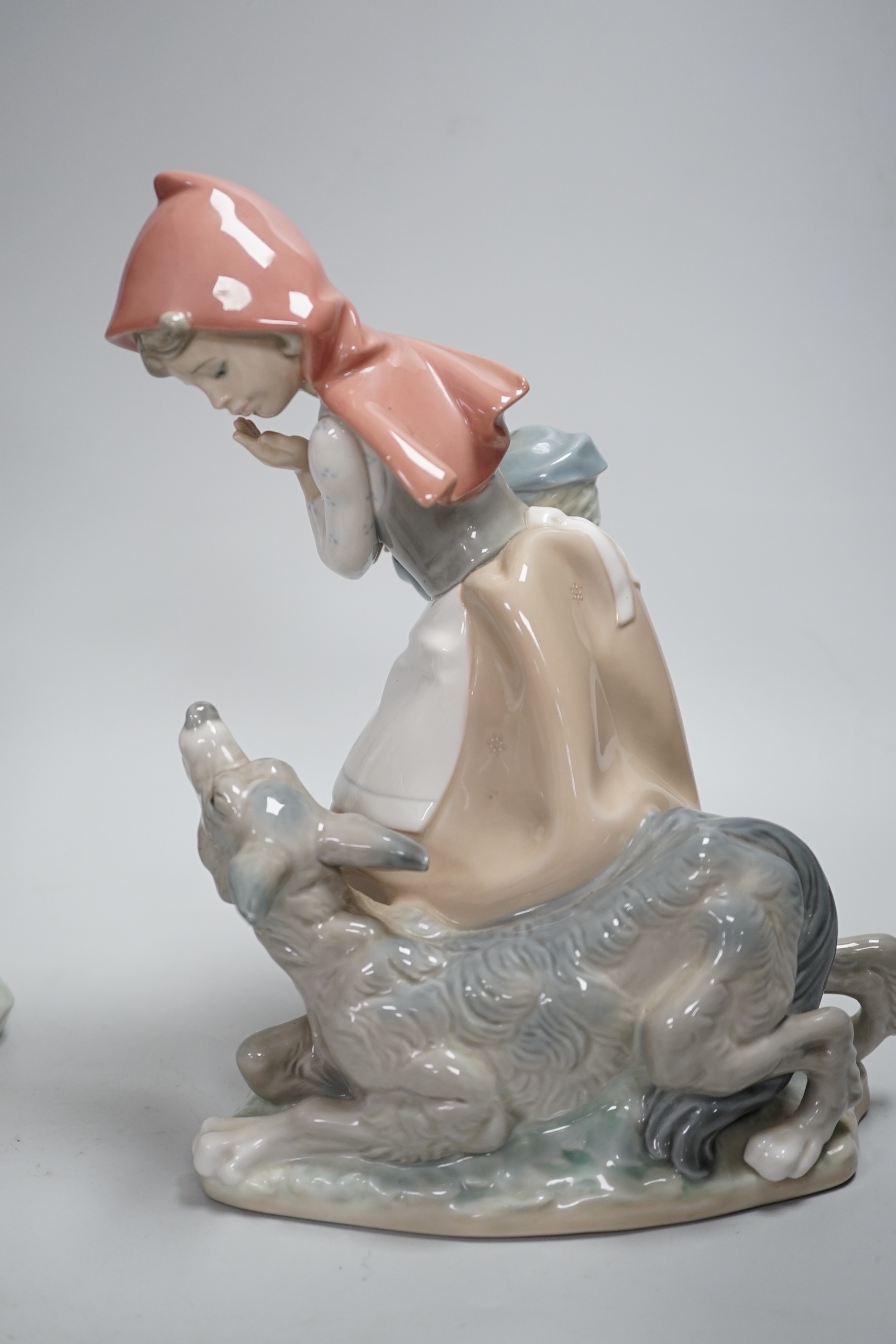 Four Lladro models, a girl potter, girl with ducks, mother and child with pottery and girl with a dog, highest 23.3cm